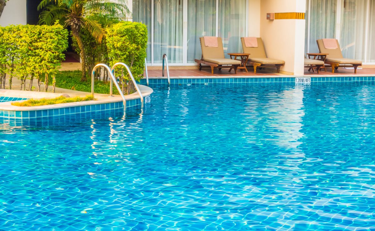 Empty Umbrella and chair around swimming pool in hotel resort